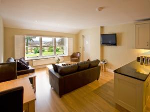 a living room with a couch and a table at Carrigbaun in Braithwaite