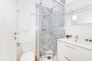 a white bathroom with a shower and a toilet at Sunny Suite Nordic - Lugano City -By EasyLife Swiss in Lugano
