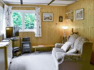 a living room with a couch and a tv at Trewartha-by-chy in Crackington Haven