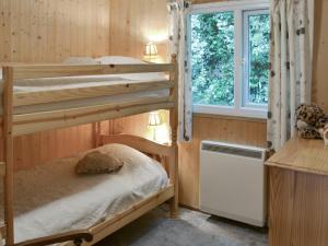 a bedroom with two bunk beds and a window at Trewartha-by-chy in Crackington Haven