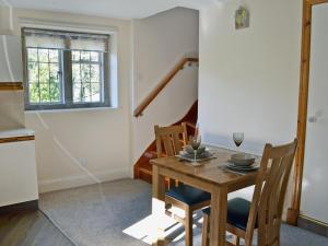 a dining room with a wooden table and chairs at The Old Mill Annexe in Hartington