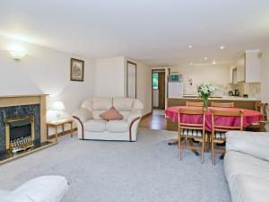 a living room with a couch and a table at Grebe Cottage in Dilham