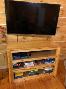 a flat screen tv sitting on top of a wooden table at Cozy Creekside Cabin in the heart of Hocking Hills in Laurelville