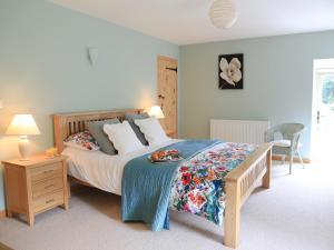 a bedroom with a bed and a table with a tray on it at West Barn in Chesterfield