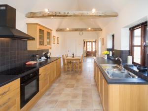 a large kitchen with a sink and a table at Brooklyn Barn in Rolleston