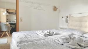 a bedroom with a white bed with towels on it at Fewo Seehaase in Radolfzell am Bodensee