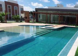 a swimming pool in front of a building at Casa praia do Francês in Marechal Deodoro