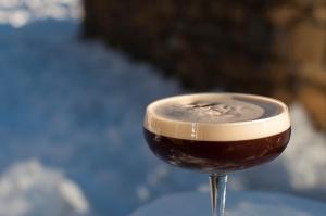 a glass of wine sitting on top of a table at Eira Ski Lodge in Baqueira-Beret