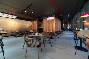 a restaurant with wooden walls and tables and chairs at Almasur Providencia in Santiago