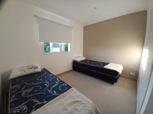 En eller flere senge i et værelse på soma departamentos