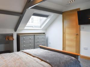 a bedroom with a bed and a skylight at Georges View in Whitby