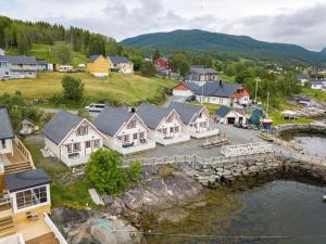 an aerial view of a town with houses and a river at Sørreisa Fiske og Feriesenter 