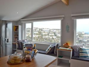 a kitchen with a table and a large window at Penfose Apartment in Mevagissey