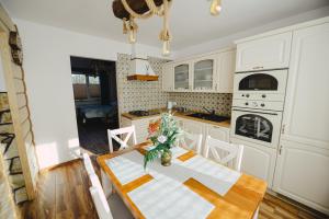 una cocina con una mesa con un jarrón de flores. en Apartament Zielony Ruczaj w Cisnej, en Cisna