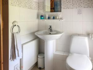 a white bathroom with a sink and a toilet at The Creamery in Kniveton