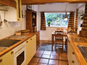 a kitchen with a table and a dining room at Gareside Lodge in Rhu