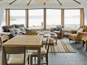 a living room with a table and chairs at Beach Bay Cottage in Mangersta