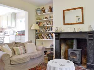 a living room with a couch and a fireplace at Sunnybank in Saint Margaret