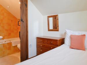 a bedroom with a bed and a sink and a bathroom at TY NANT-oxl in Gwynfe