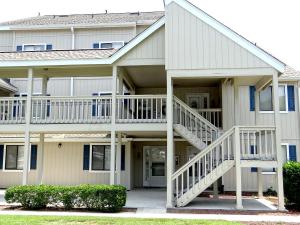 a apartment building with a staircase in front of it at 35B GCR Everything Zen A Quiet Escape in Myrtle Beach