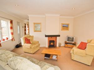 a living room with two couches and a fireplace at Curlew Cottage - E3752 in Leverton