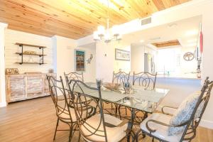 a dining room with a table and chairs at Barefoot Trace 109 in St. Augustine