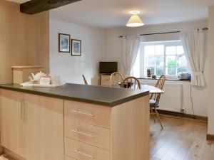 a kitchen with a counter top and a dining room at Daisy Cottage in Thornton Dale