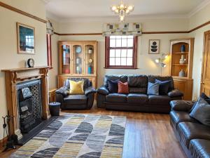 a living room with a couch and a fireplace at Brambleside in Mawbray