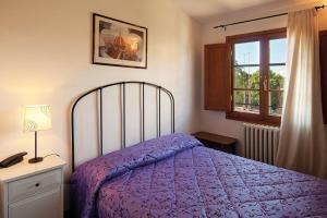 a bedroom with a purple bed and a window at B&B Arco Antico in Florence