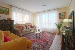 a living room with a couch and a table at La Luz de La Concha in Suances