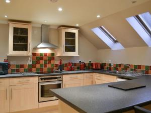 a kitchen with skylights in the ceiling of a kitchen at The Steadings Apartment in Kinlochmore