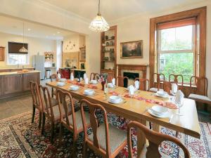a large dining room with a table and chairs at Hazel Grove House in Beetham
