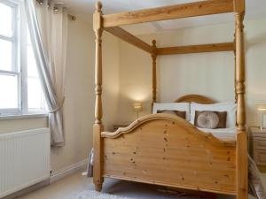 a four poster bed in a bedroom with a window at Belfrey House in York