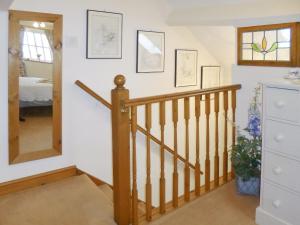 a staircase in a house with a mirror at The Old Coach House in Burythorpe