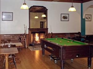 a billiard room with a pool table and a fireplace at Upper Tower - 15458 in Cladich