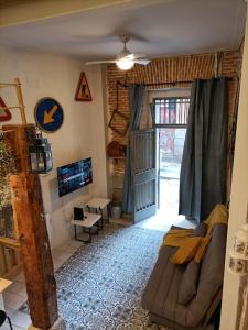 uma sala de estar com um sofá e uma televisão em Refuge in Madrid em Madri