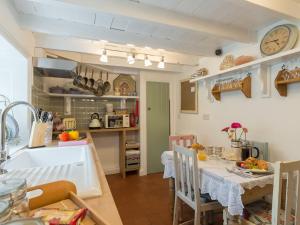 a kitchen and dining room with a sink and a table at Brewery House Cottage in Bishop Middleham