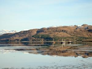 a large body of water with mountains in the background at Carron House in Lochcarron