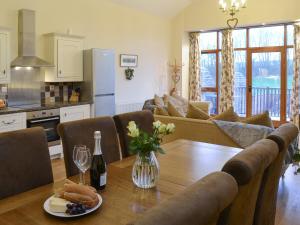 een keuken en een woonkamer met een tafel en stoelen bij Barn Owl - 27820 in Westleigh