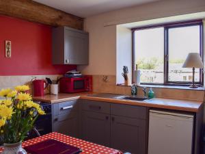 a kitchen with a sink and a counter top at Cherry - 28556 in Brighstone
