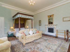 a living room with a bed and a couch at Symbister Suite in Turriff