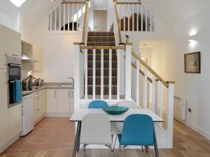 a kitchen and dining room with a table and chairs at The Barn in Ankerville