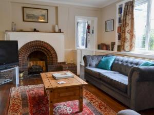 a living room with a couch and a fireplace at Ivy-w40854 in Llanddona