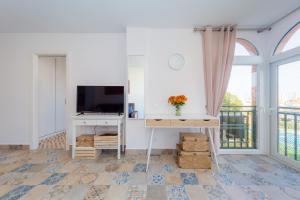 Televízia a/alebo spoločenská miestnosť v ubytovaní Apartamento Torresol