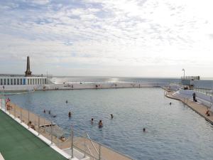 a group of people swimming in a swimming pool at Suncroft in Praa Sands