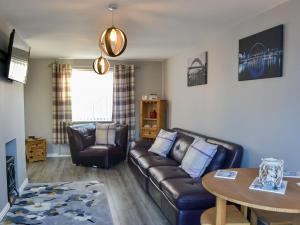 a living room with a couch and a table at Seashells By The Sea in Newbiggin-by-the-Sea
