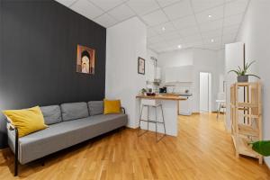 a living room with a couch and a kitchen at Holiday 33 Apartment J Prenzlauerberg in Berlin