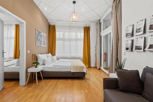 a living room with a bed and a couch at Holiday 33 Apartment J Prenzlauerberg in Berlin