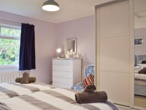 a bedroom with a bed and a mirror at Little Croxley in Wroxall