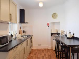 a kitchen with a sink and a counter top at Little Lismoy in Sandown